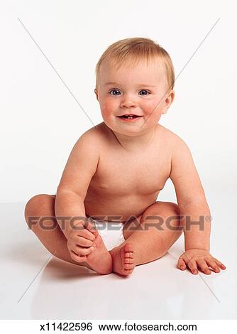 Young Happy Baby With Blonde Hair Blue Eyes Is Sits In Diaper