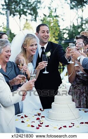 Bride Groom And Guests Raising Toast With Champagne At Reception