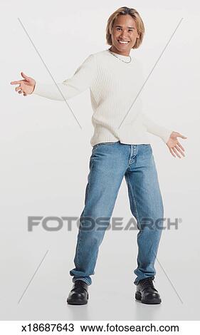 A Handsome Asian Young Man With Bleached Hair Stands Gesturing