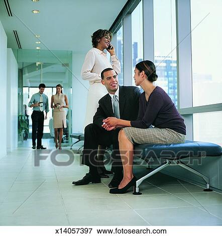 Picture - Five Colleagues Relax and Talk in an Office Corridor. Fotosearch - Search Stock Photography, Photos, Prints, Images, and Photo Clipart