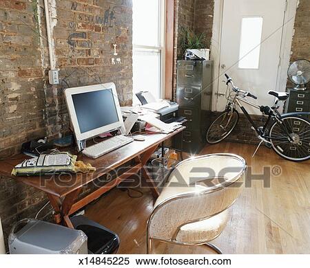 Pc Desk And Bicycle Inside An Apartment Stock Photography