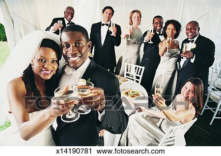 Group Of People Toast A Bride And Groom At A Wedding Reception In