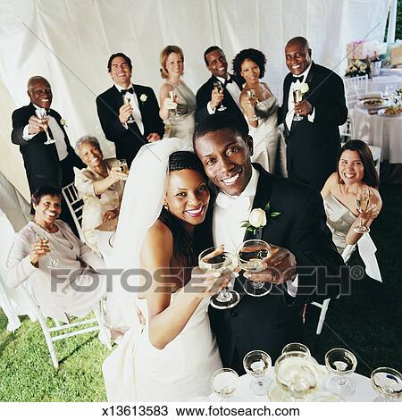 Guests Toast The Bride And Groom At A Wedding Reception In A