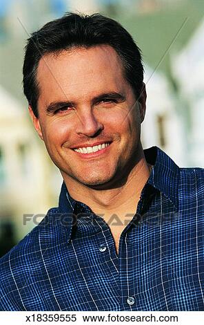 Portrait Of A Man With Short Brown Hair And A Checked Shirt Stock