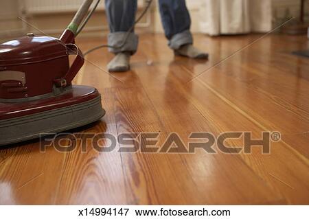 Man Polishing Wooden Floor Low Section Stock Photo X14994147
