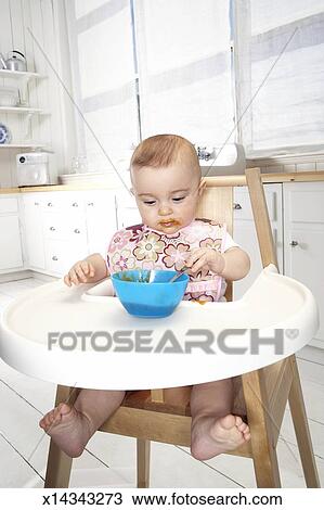 Baby Girl 5 7 Months In High Chair Eating From Bowl Stock Image