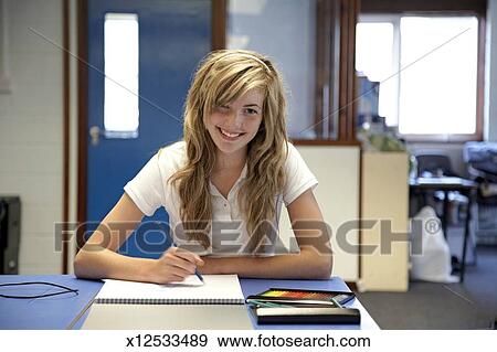 Teenage Girl 14 16 Sitting At Desk Drawing In Sketchbook