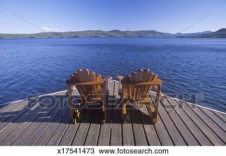 'Two Adirondack chairs on a deck overlooking Lake George ...