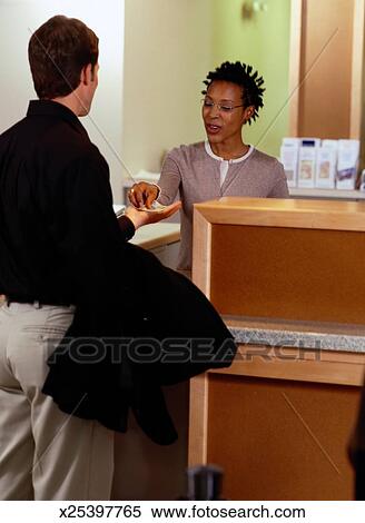 Bank Teller Giving Customer Money Stock Photography X25397765