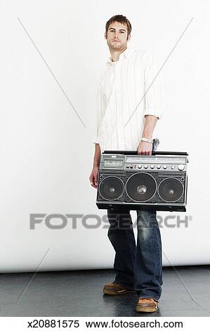 Young man carrying boom box, portrait Stock Photography | x20881575 ...