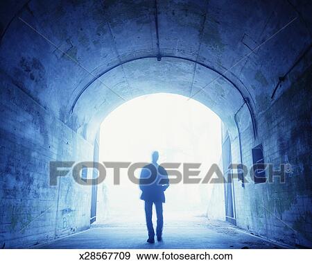 Stock Photograph of Man walking through tunnel, rear view ...
 Silhouette Man Walking Tunnel