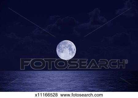 Full Moon Over Ocean Night Stock Photo