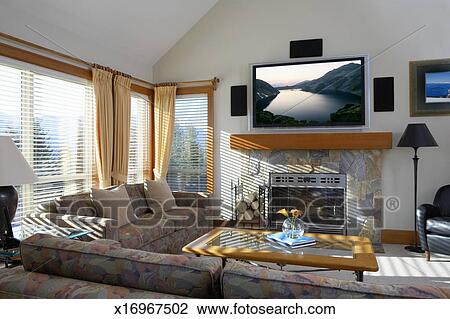 Living Room With Flat Screen Television Above Fireplace Stock