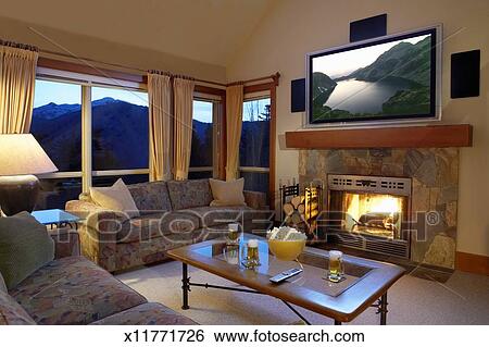 Living Room With Flat Screen Television Above Fireplace Stock