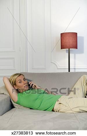Stock Photo Of Woman Lying On Sofa Using Mobile Phone Portrait Stock Photo Woman Lying On Sofa Using Mobile Phone Portrait Fotosearch Search