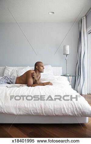 Shirtless Young Man Lying On Bed Profile Stock Photography