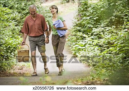 https://fscomps.fotosearch.com/compc/FSD/FSD364/senior-man-and-woman-walking-through-stock-images__x20556726.jpg