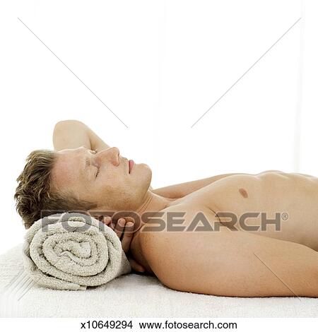 Side Profile Of A Young Man Sleeping With A Rolled Towel For A