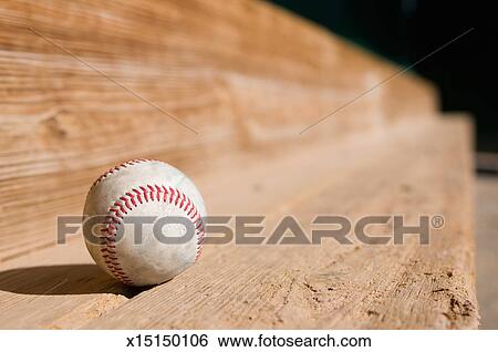 A Baseball On The Dugout Bench Stock Photograph X15150106