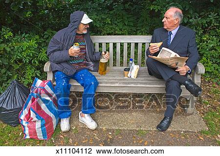 Drunk Tramp And A Businessman On Park Bench Stock Image