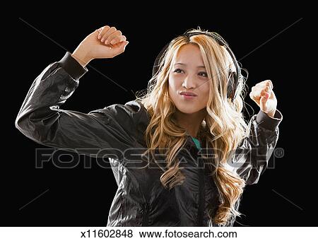 Asian Hip Hop Girl Dancing And Listening To Music Stock Photo