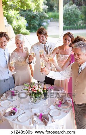 Guests Toasting With Champagne At Wedding Reception Stock