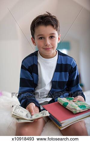 Boy with currency View Large Photo Image Stock Photo - Boy with currency. Fotosearch - Search Stock Images, Poster Photographs, Pictures, and Clip Art Photos