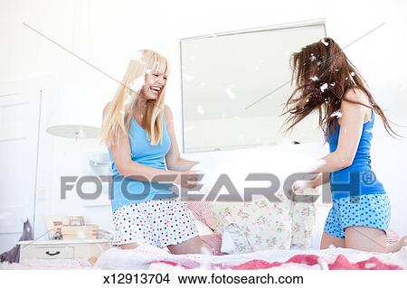 Women Pillow Fighting In Bedroom Picture X12913704 Fotosearch