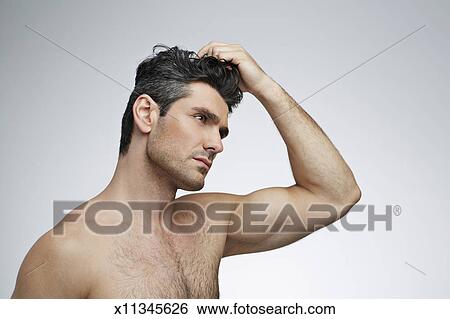 Beauty Shot Of Man Setting Hair With Wax Stock Photograph