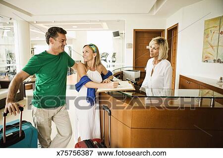 Front Desk Clerk Welcoming Couple On Vacation In Tulum Mexico Who