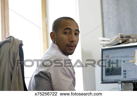 Person Behind Desk Looks To Camera Stock Image X75256722