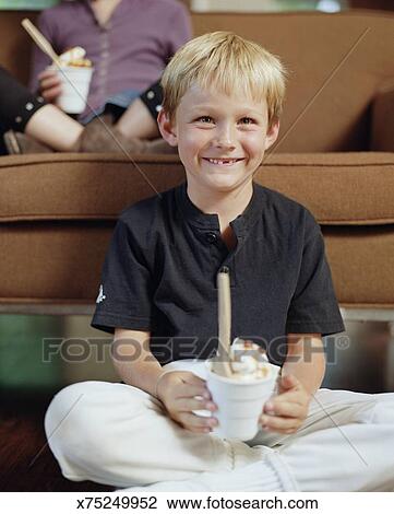 smiling-young-boy-holding-ice-cream-stock-photo__x75249952.jpg
