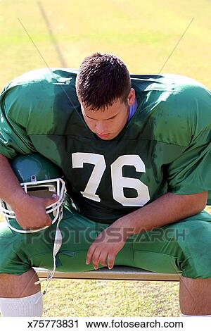 Football Player Sitting On Bench Stock Image X75773831 Fotosearch