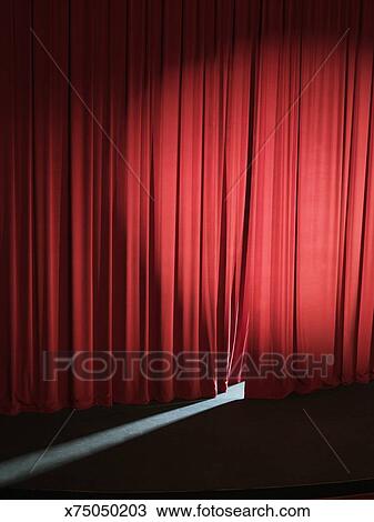 Empty Stage With Curtains Slightly Open Letting Light Through