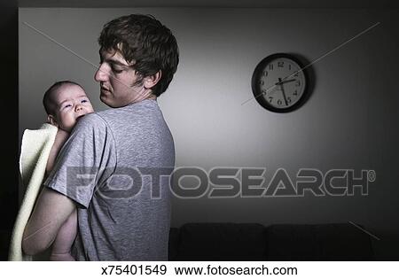 Father Comforting Crying Baby Stock Photo X75401549 Fotosearch