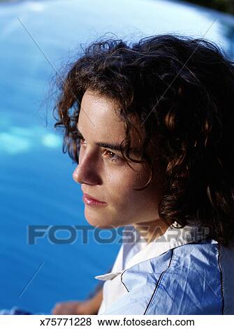 Teenage Boy 15 17 With Curly Hair Looking Into Distance Close