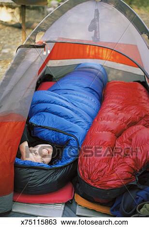 Woman In Sleeping Bag Inside Tent Stock Image
