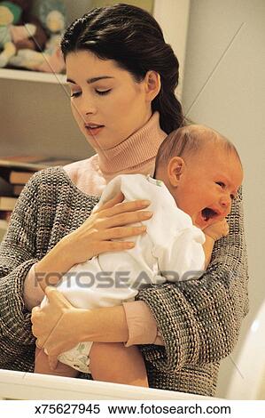 Mother Comforting A Crying Baby Stock Photography X75627945