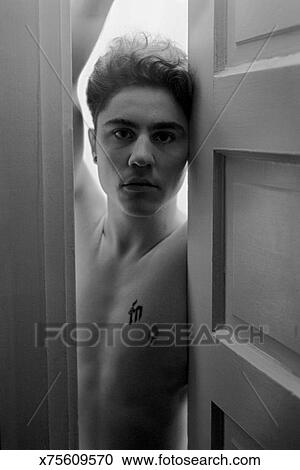 Shirtless Man Looking Through Door Opening Stock Image X75609570