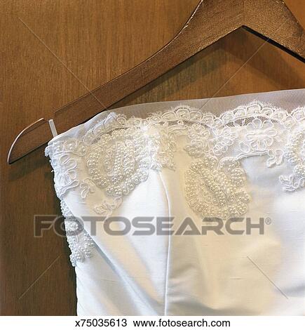 Wedding Dress Hanging On Coat Hanger Stock Image X75035613