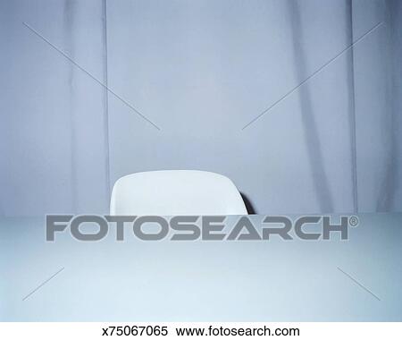 White Chair Behind Desk Close Up Stock Photography X75067065