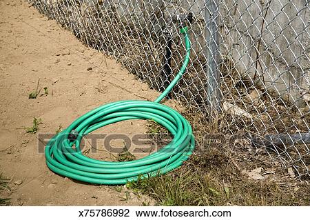 Coiled Hose Attached To A Water Faucet Stock Image X75786992