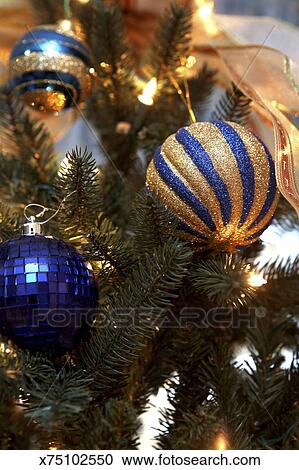 A Detail Shot Of A Christmas Tree Decorated In Blue And Gold