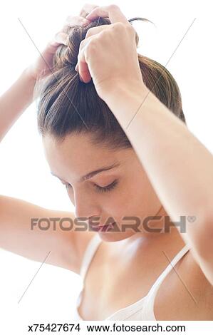 Woman Indoors Putting Hair Up Picture X75427674 Fotosearch