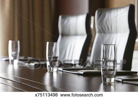 A Boardroom Table Is Set Up For A Meeting Stock Photo