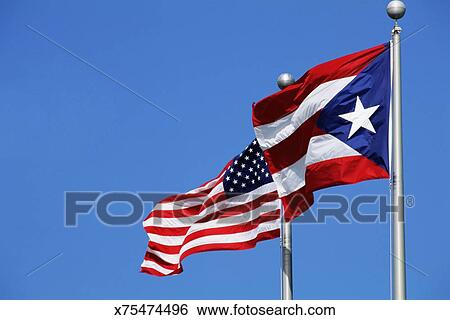 American And Puerto Rican Flags Blowing In Wind Stock Photograph