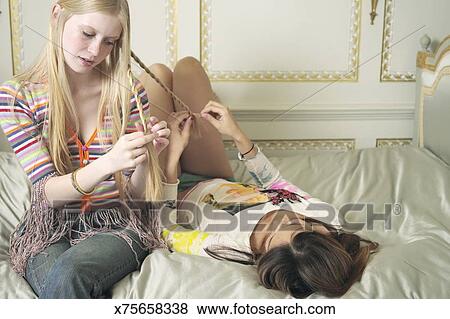 Teenage Girls Braiding Hair Stock Photo X75658338 Fotosearch