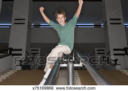 Boy Sliding Down A Banister Stock Photo X75169868 Fotosearch