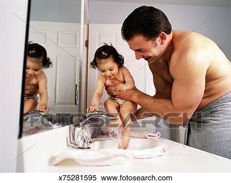 Father Washing Baby Daughter S 9 12 Months Feet In Bathroom Sink Stock Photography