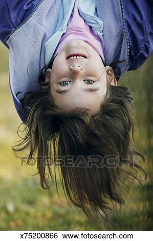 Girl Hanging Upside Down Stock Photograph X75200866 Fotosearch